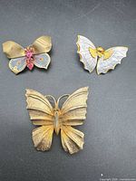 Group shot of three butterfly brooches