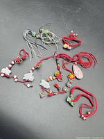 All charms laid out showing variety of cords and pendants