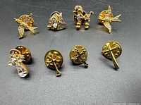 Wide shot showing all eight gold-tone lapel pins