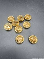 Group of nine gold-tone filigree button covers