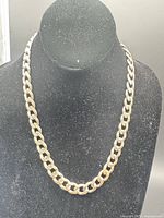 Necklace displayed on bust showing overall curb link design