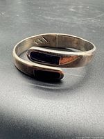 Cuff bracelet displaying overall form and inlays