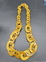 Full view of mustard yellow oversized link necklace