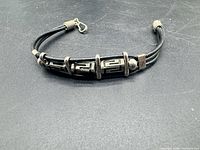 Bracelet laid flat showing clasp and Greek key links
