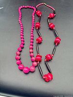 Two necklaces laid side by side showing full length and bead styles