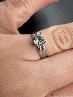 Ring on finger showing overall design and stone