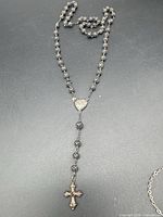 Full view of silver filigree bead rosary laid out