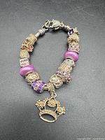 Full view of charm bracelet showing all beads and crown charm