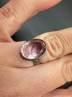 Top view of sterling silver ring showing faceted oval amethyst stone