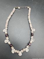 Full view of beaded necklace laid flat showing bead arrangement and clasp