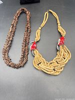 Both necklaces laid flat showing full length and styles