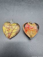 Two Murano glass heart pendants side by side