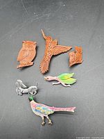 Group shot of all seven animal brooches