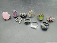 All ten vintage rings on black surface