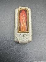 Closed shrine front showing sunburst cross and saint window