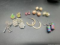 All ten pairs of earrings laid out