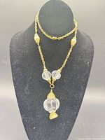 Full necklace on display bust showing chain, beads, pendant