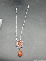 Full view of necklace laid out showing pendant and chain