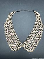 Full view of faux pearl collar necklace showing lattice design and clasp