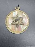 Front view showing iridescent mother-of-pearl background and Star of David motif