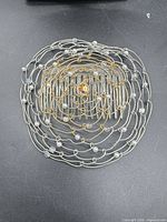 Top view of entire wire kippah showing circular design and beads