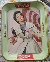 Front view of Coca-Cola advertising tray with woman graphic