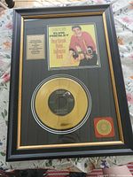 Full view of framed gold record display showing frame, record, cover art, plaque and seal