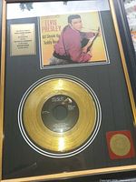 Overall view of framed gold record plaque with photo and dedication plate