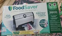 Front of retail box showing FoodSaver 3800 Series vacuum sealer and bonus pack details