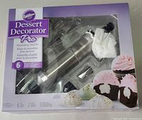 Front of sealed Wilton Dessert Decorator Pro box showing stainless steel decorator and tips