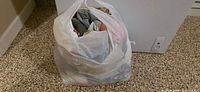 Closed plastic bag full of textiles