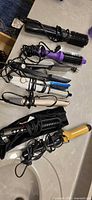 All seven hair styling tools laid out on countertop