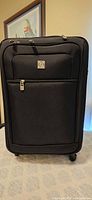 Front view of black Pierre Cardin softside suitcase on spinner wheels