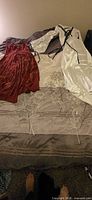 Both Renaissance dresses laid out on bed