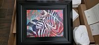 Framed zebra painting in shipping box with packing