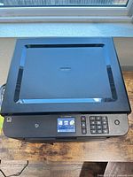 Top view showing flatbed scanner lid, control panel with touchscreen and keypad