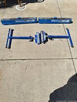 Two folded connector rails and collapsed sawhorse/stand