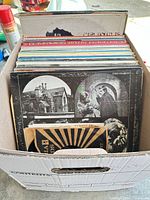 Box containing stacked 12" LPs and some 7" singles