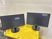 Front view of both Acer monitors powered on