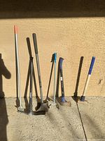 All eight tools lined against wall for size and type reference