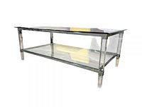 Side angle showing overall structure, glass top, acrylic legs, lower shelf