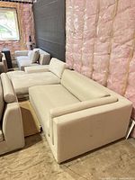 Loveseat front and side view on floor with cushions visible