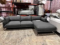 Front view of the Jamara sectional showing right-facing chaise, dark gray fabric and metal legs