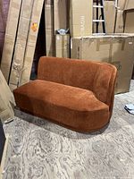 Front view of rust velvet settee showing seat and back