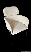 Front three-quarter view of white corduroy chair showing upholstery and leg style