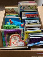 Box of assorted children’s books showing mix of board, hardcover and pop-up formats
