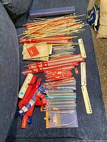 Full lot laid out: loose straight needles, packaged needles, accessories