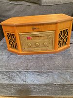 Front view of closed Emerson stereo console showing light oak cabinet and control panel