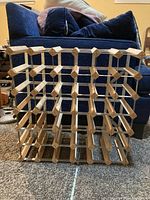 Front view of freestanding wine rack showing wood and metal lattice structure
