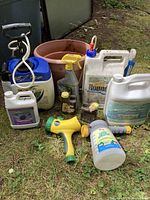 Group shot of all items including sprayers, containers, hose nozzle and pot